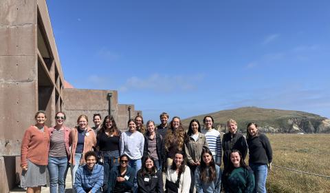 A group posed outside of the Bodega Marine Laboratory on the Bodega Marine Reserve