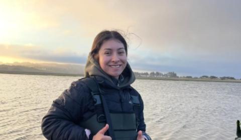 SRJC Intern Vanessa Cordova standing thigh deep in water during fieldwork