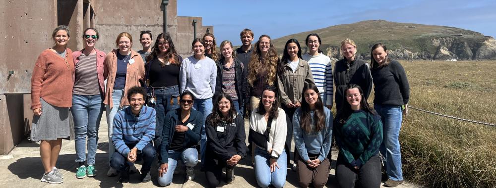 A group posed outside of the Bodega Marine Laboratory on the Bodega Marine Reserve