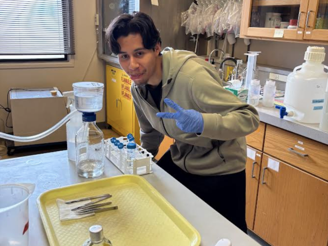 SRJC Intern Jafet Torres posing with his experiment