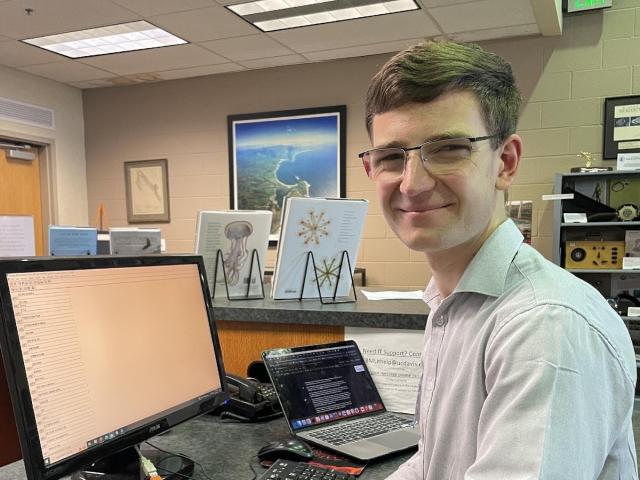 A person sitting at a computer in the Cadet Hand Library at BML
