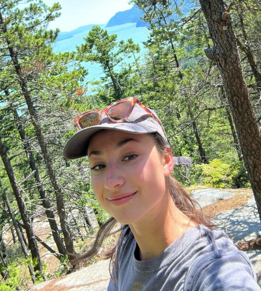 A portrait of Ana Roden standing in front of a redwood forest