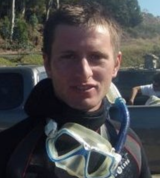 A profile image of a person with short hair wearing snorkel gear looped around their neck