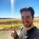 A portrait of Diego Scaturchio standing in front of a coastal prairie