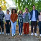 A group of ten scholars standing outdoors